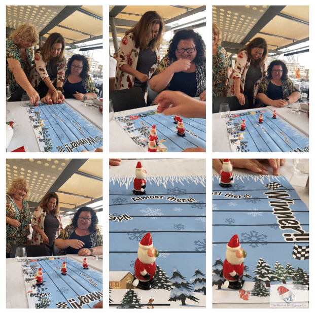 Maria, Angela, and Robyn line up their wind-up Santas and cheer them on as they slowly race.